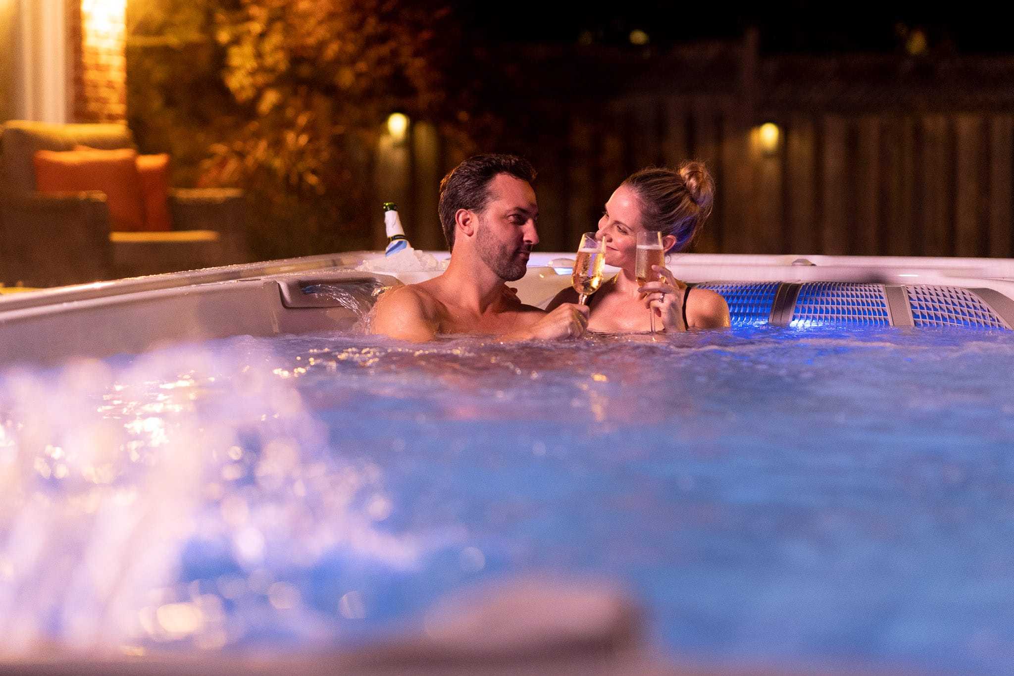 Hydropool 4 Couple relaxing in romantic Hot Tub with glass of champagne